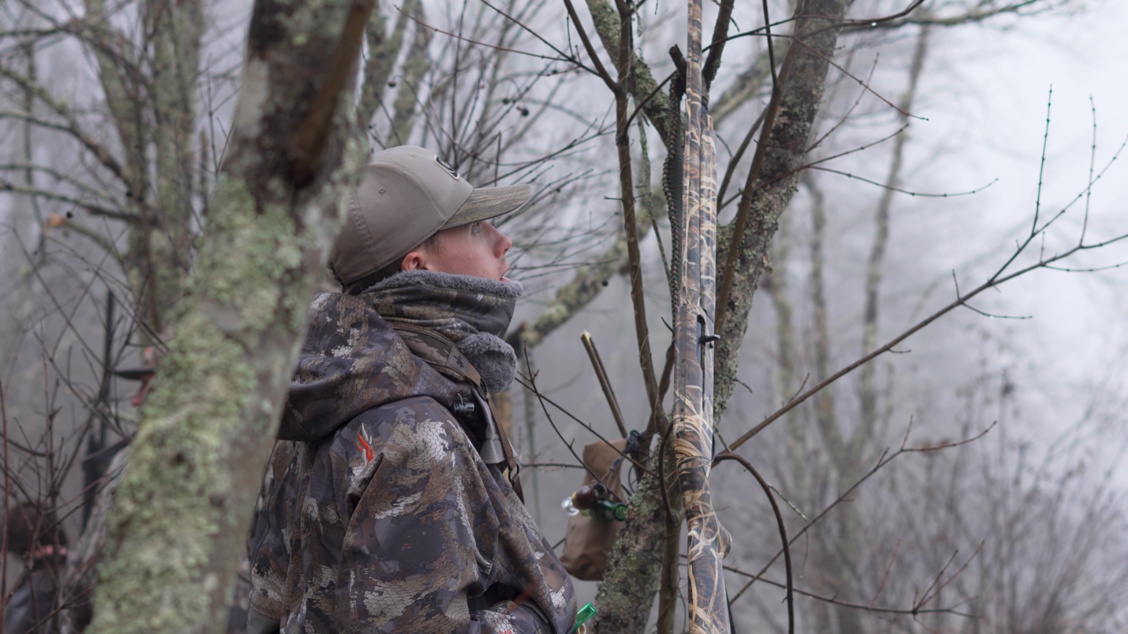 Divine Outdoors Co. hunter in the fog, treestand setup